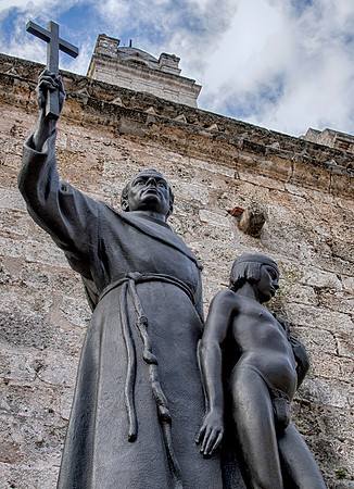 Junipero Serra with Juaneno Indian boy next to Basicillica de San Francisco de Asis