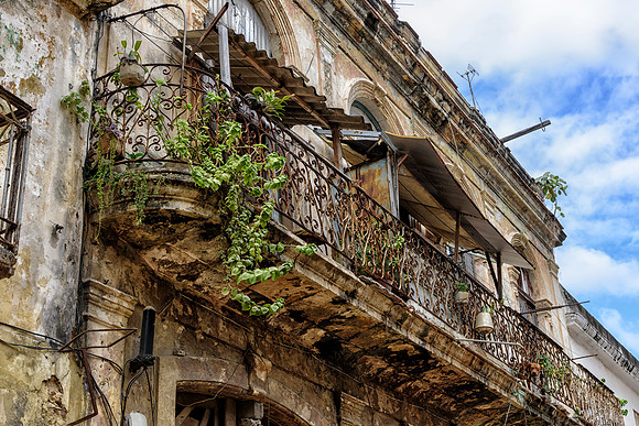Balcony in state of decay with signs of life